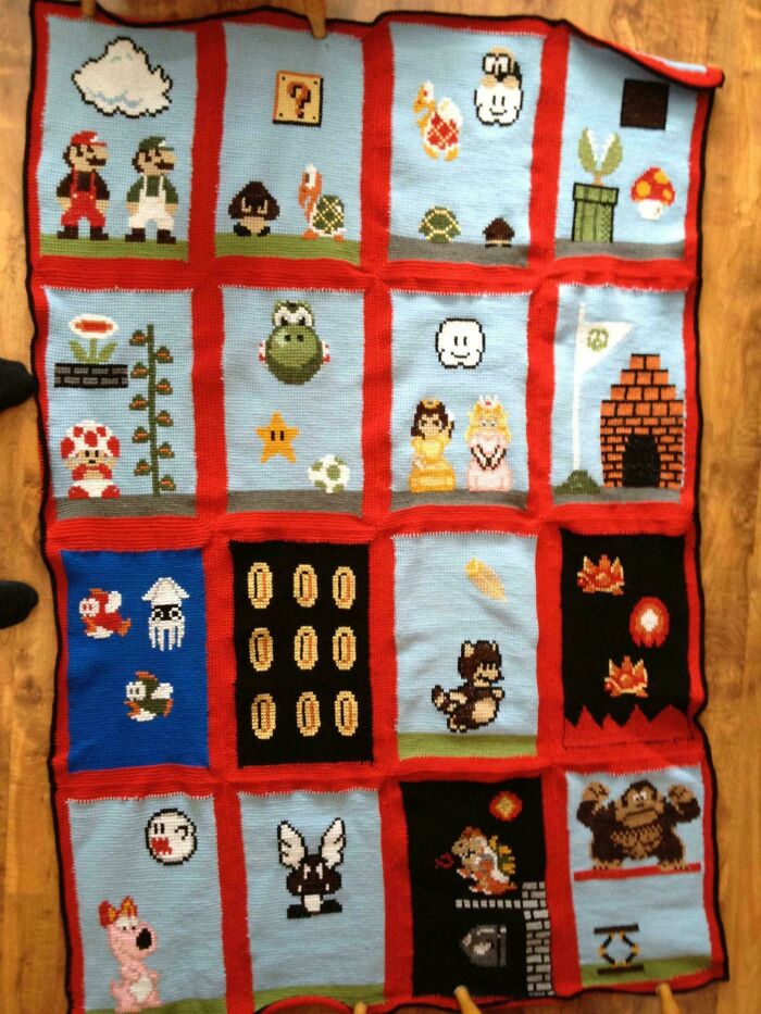 Colorful knitted blanket showcasing retro video game characters, crafted with love by amazing mothers-in-law.