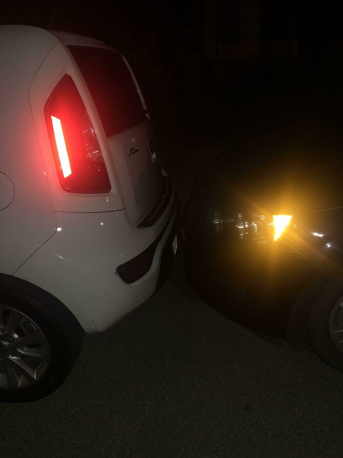 Two cars parked in close proximity at night, highlighting infuriating family members' parking habits.