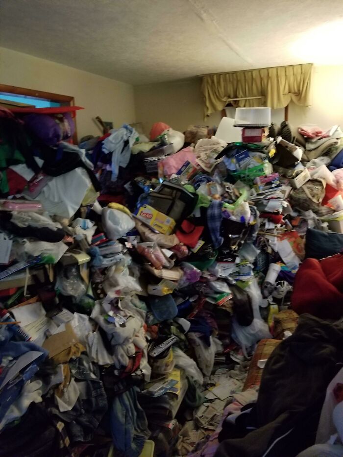 Cluttered room representing infuriating family members with piles of clothes and items scattered around.