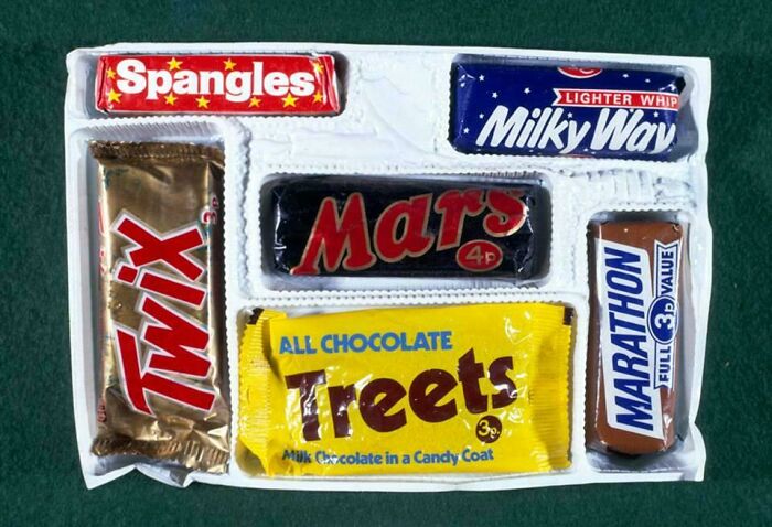 Vintage candy selection featuring Spangles, Milky Way, Mars, Twix, Treets, and Marathon bars in retro packaging.