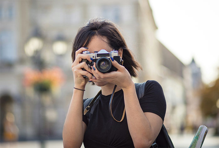 "Woman photographing a view in Paris, capturing a memorable moment amid a fake proposal prank opportunity. "Woman photographing a view in Paris, capturing a memorable moment amid a fake proposal prank opportunity.