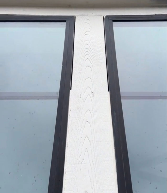 Close-up view of poorly aligned window frames in a $1,600,000 home built 2 years ago, highlighting construction issues.