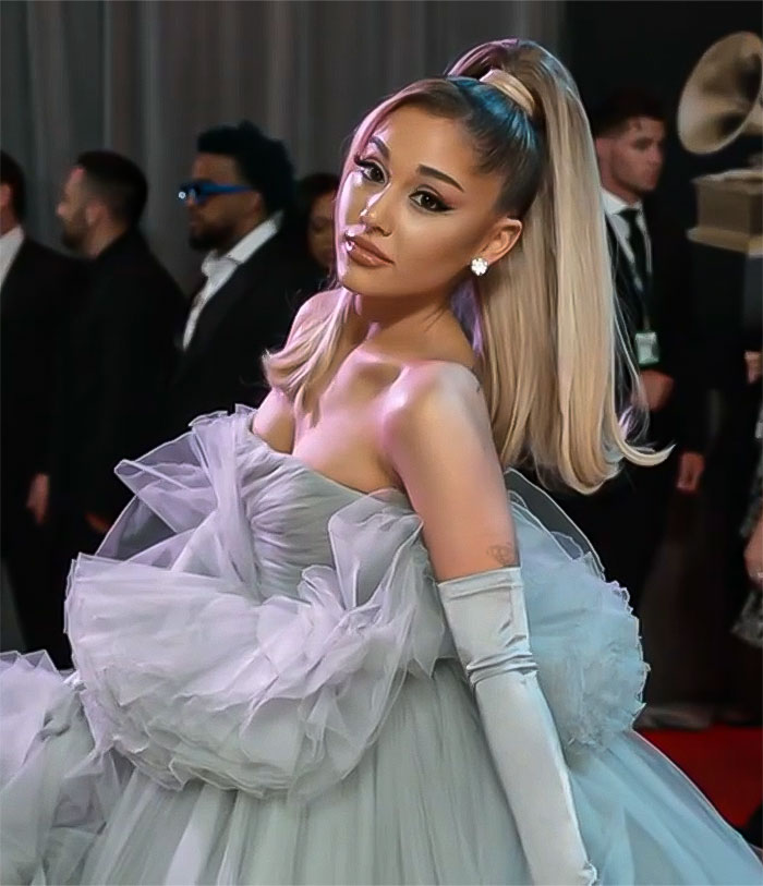 Ariana Grande at movie premiere in a grey dress, sparking concern over her "robotic" appearance.