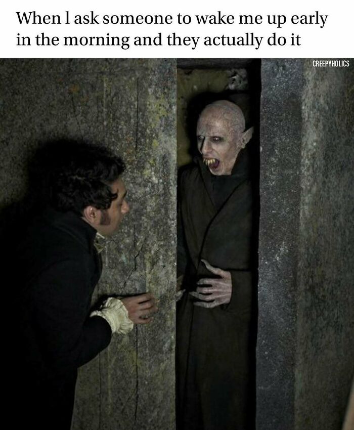 Man startled by vampire in a horror meme twist.