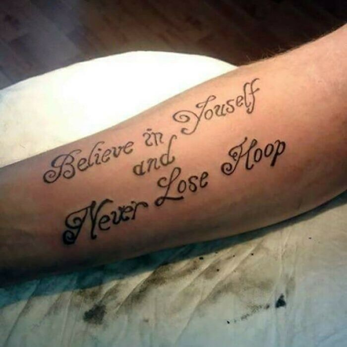 Arm tattoo with incorrect spelling, intended for motivational message, representing permanent mistake.
