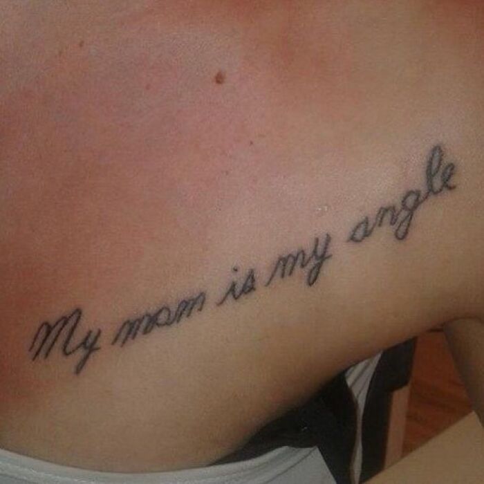 Tattoo mistake reading "My mom is my angle" in cursive script.