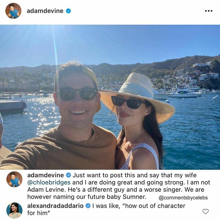 Celeb couple by the water, with a funny comment about names, enjoying a sunny day with mountains in the background.
