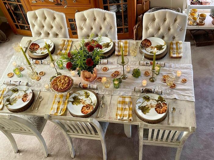 Elegant Thanksgiving table setting with floral plates, candles, and centerpiece. Perfect for festive home decorating ideas.
