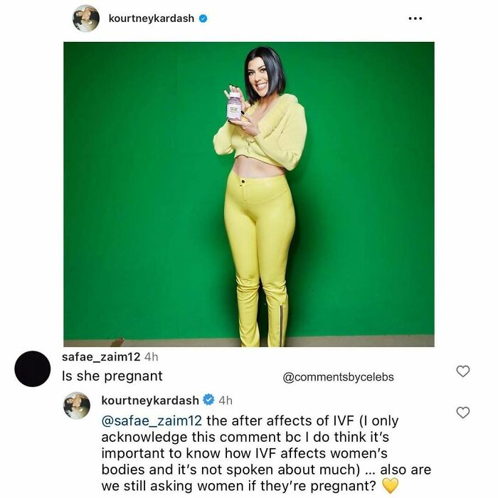 Celebrity responds humorously to pregnancy comment while wearing a yellow outfit against a green backdrop.