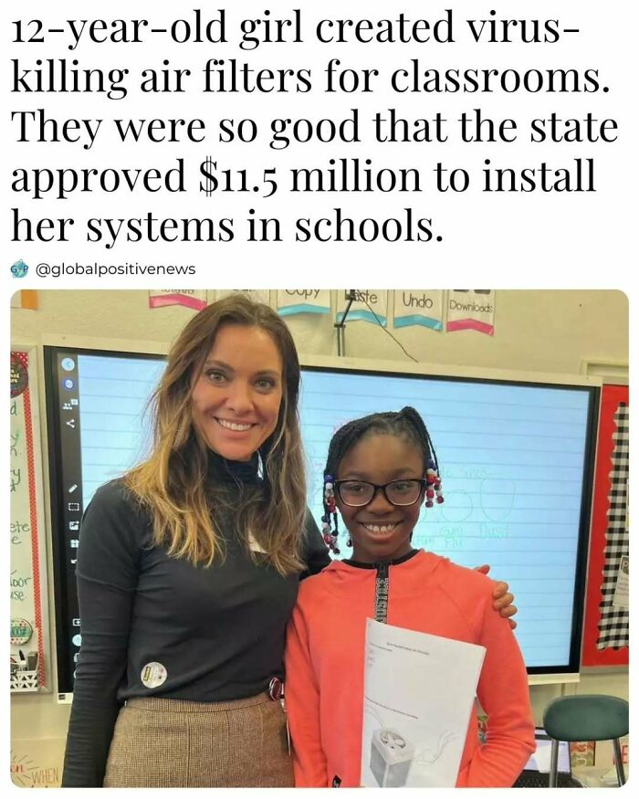 12-year-old inventor of virus-k*****g air filters for schools, standing in a classroom, smiling beside a woman.