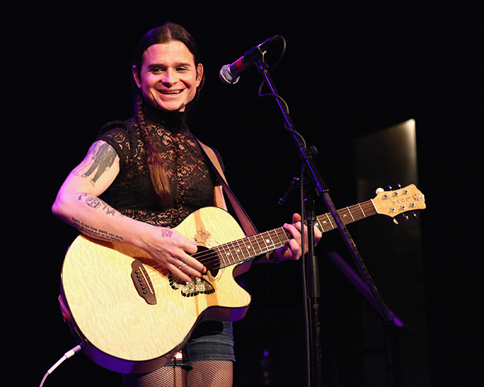 Rock singer performing on stage with a guitar. Rock singer performing on stage with a guitar.