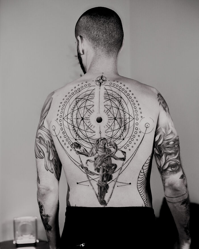 Back tattoo with geometric and mythological design by Monolith Studio artist.
