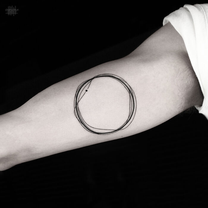 Minimalist abstract tattoo design on forearm by Monolith Studio artist.