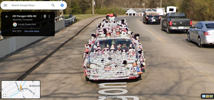 A car covered with plush toys on Google Street View; a funny and weird life scene captured on the road.