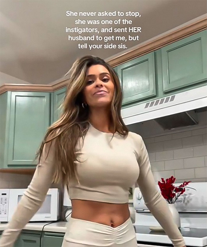 Young woman standing confidently in a kitchen, related to leaked footage from Mormon soft-swinging parties scandal.