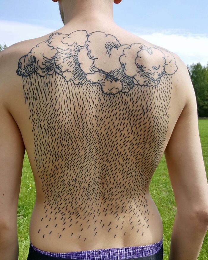 Back tattoo of clouds with rain, illustrating an epic tattoo fail shared online.