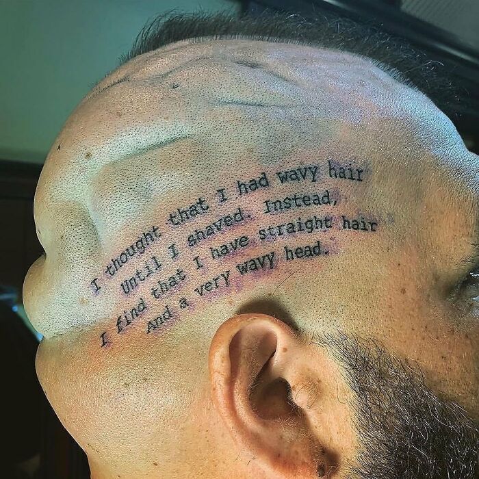 A humorous tattoo fail on a person's head with wavy text reflecting the head's shape.