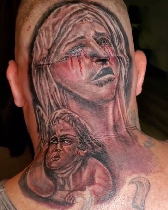 Epic tattoo fail depicting two solemn faces on a person's head and neck in vivid detail.
