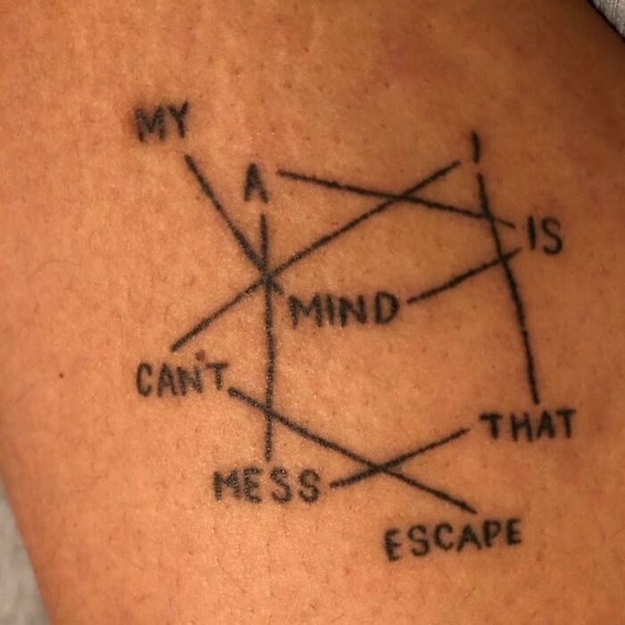 Epic tattoo fail with overlapping words creating a confusing design.