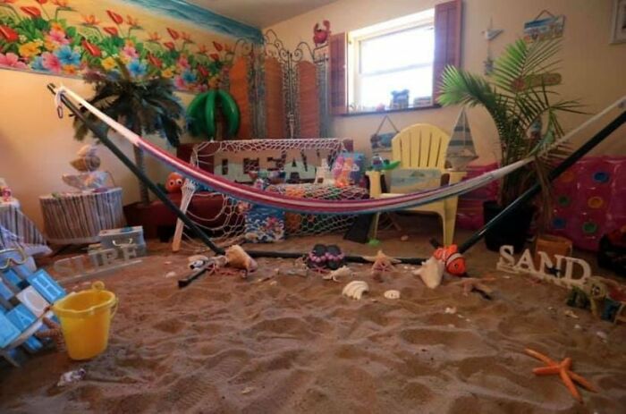 Indoor room designed with sand floor and hammock, showing a creative design that will require cleaning efforts