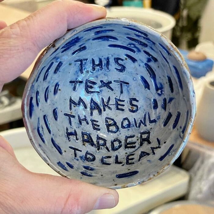 Ceramic bowl with text inside highlighting a design that unintentionally makes cleaning difficult.