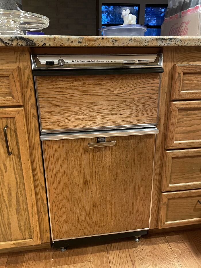 KitchenAid Compactor in a vintage wooden cabinet, representing a once luxurious but now obsolete home feature.