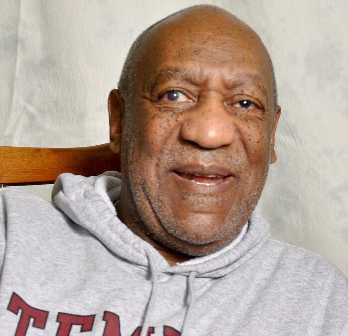 A person in a gray hoodie sitting on a wooden chair, associated with celebrities-people-lost-respect.