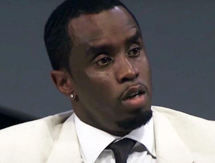 A man in a white suit with a serious expression, related to celebrities people lost respect for.