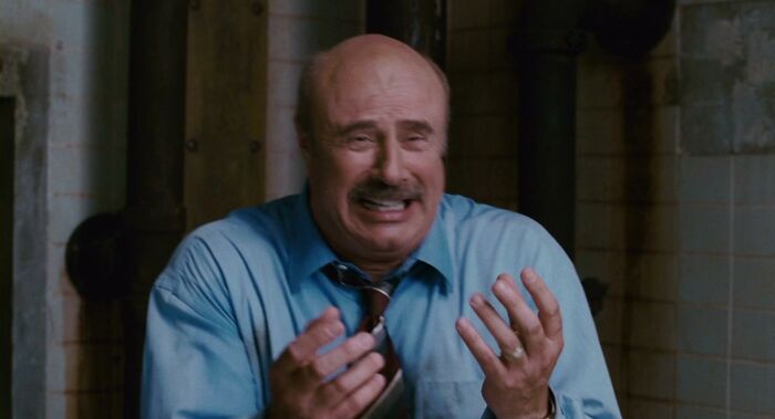 A distressed man in a blue shirt making a dramatic gesture, representing the concept of celebrities-people-lost-respect.