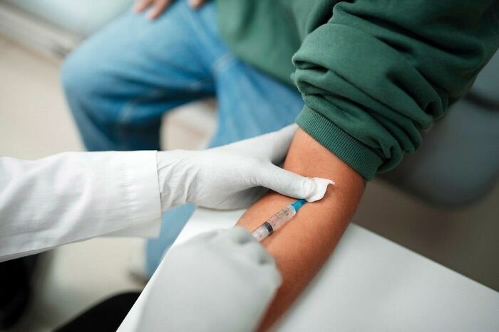 Person getting a blood test, potentially related to low iron levels.