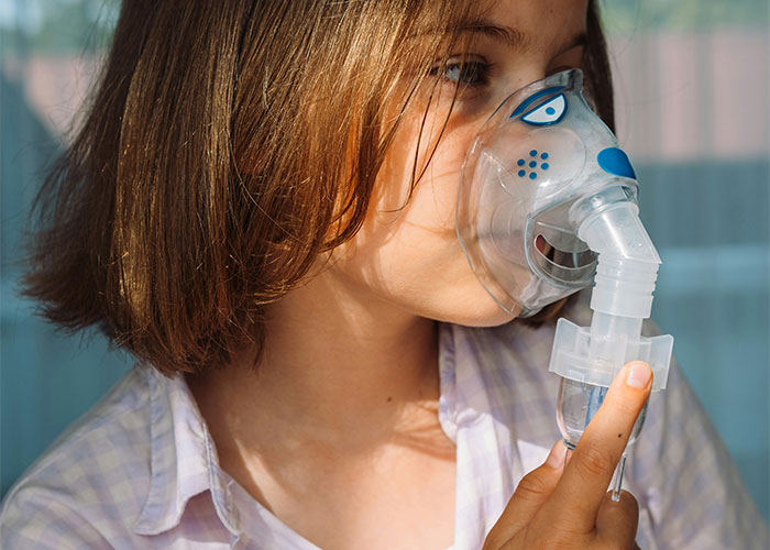 Child using an inhalation mask during therapy, illustrating a gut feeling scenario.