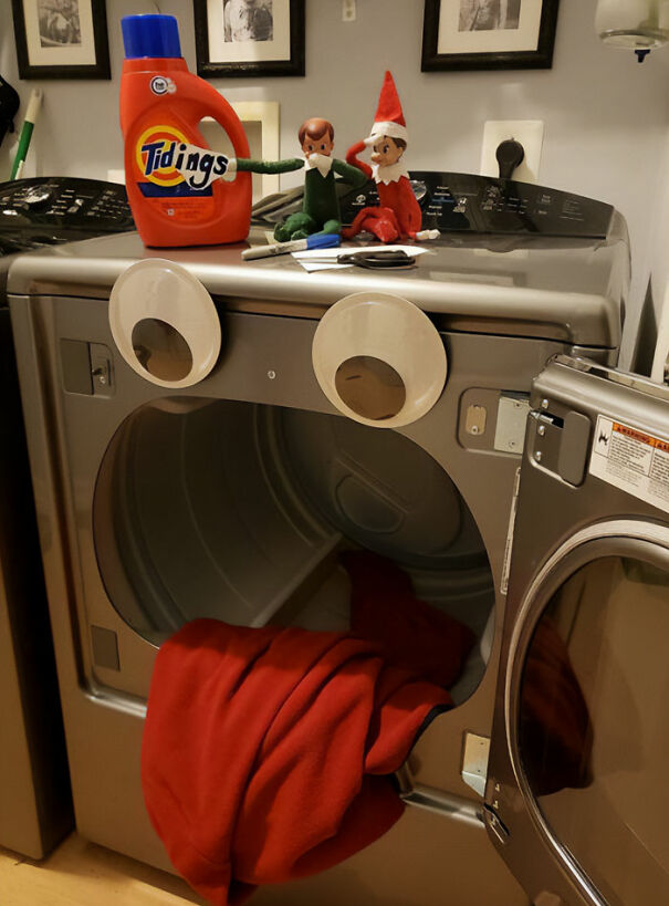 Elf On The Shelf idea with elves on a dryer decorated with googly eyes and a blanket tongue for mischief.