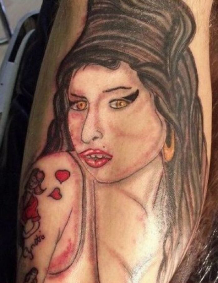 A tattoo mistake depicting a stylized woman with exaggerated features on an arm.