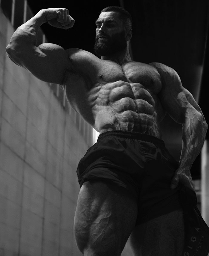 Grayscale image of muscular man flexing bicep, symbolizing extreme masculinity linked to Giga Chad meme.