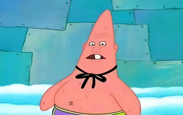 A goofy character with an elongated head, wearing swim trunks and a black bow, showcasing “goofy ahh” meme humor.