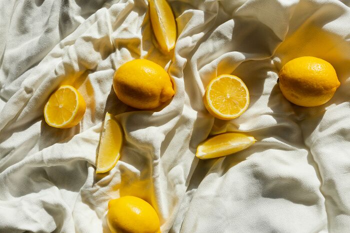 Fresh lemons on white fabric, embodying the concept of smell and happiness.