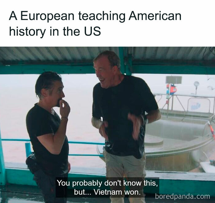 Two men standing on a boat, one explaining history humorously, with the caption about the Vietnam War. Historical memes theme.