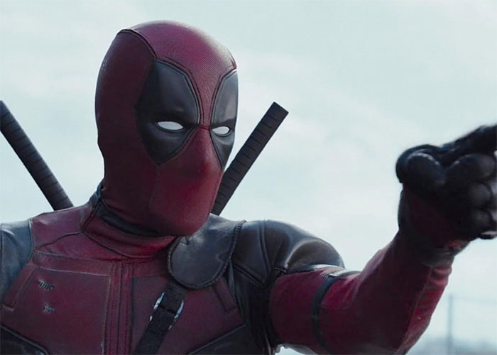 Deadpool in costume, pointing forward, showcasing a flawless portrayal of the character.