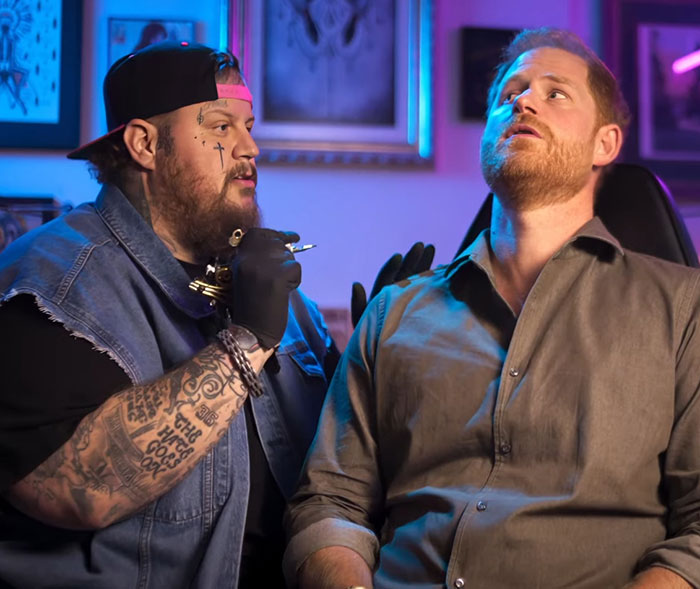 Tattoo artist giving neck tattoo in studio, highlighting ego driven controversy. Tattoo artist giving neck tattoo in studio, highlighting ego driven controversy.