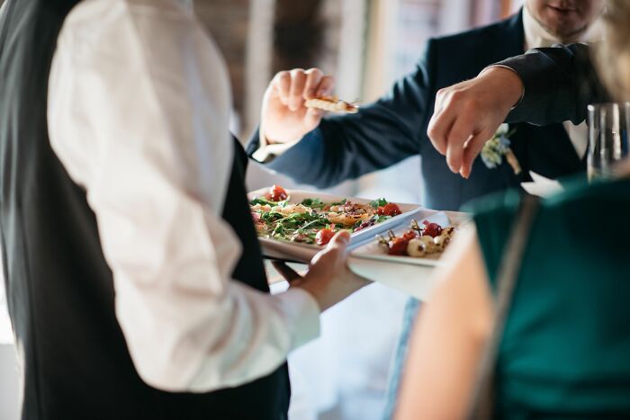 Wedding guests enjoy appetizers, capturing the vibrant atmosphere of unexpected events during ceremonies.