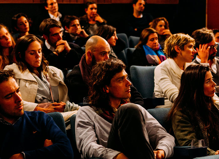 Audience attentively listening at a Hollywood industry event, revealing secrets about the entertainment world.