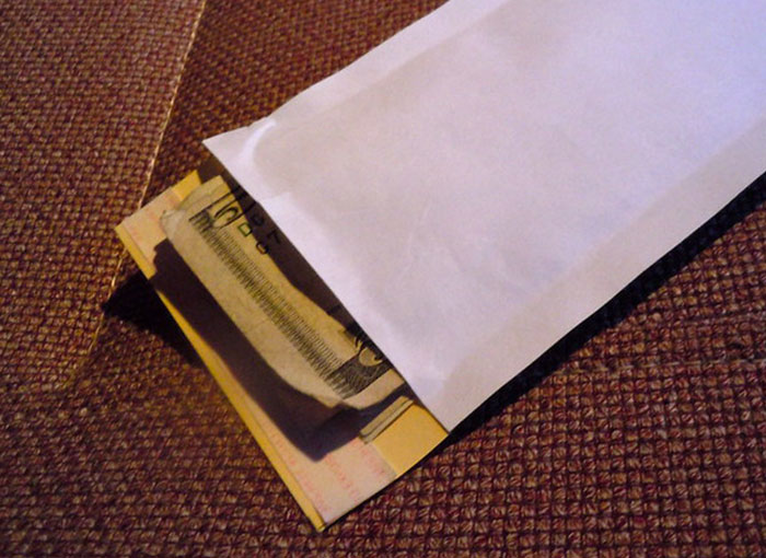 Envelope with cash, symbolizing dark secrets in the Hollywood entertainment industry.