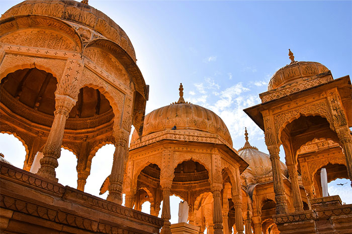 Hyped travel destination with ornate stone architecture under a blue sky.