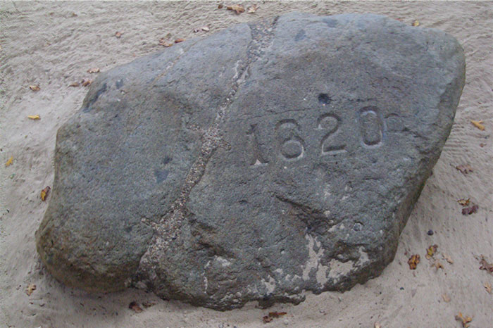 Plymouth Rock with engraved year 1620, a travel destination some find disappointing.