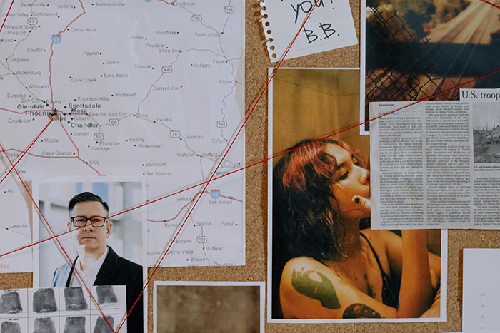 Investigative board featuring a map, photos, and articles related to a missing persons case.