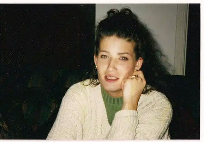 A woman with dark hair and a white sweater, related to chilling missing persons cases, looks directly at the camera.