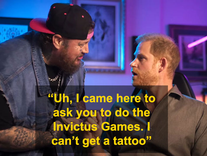 Two men in a tattoo parlor discussing tattoos, with tattoo equipment in view. Two men in a tattoo parlor discussing tattoos, with tattoo equipment in view.