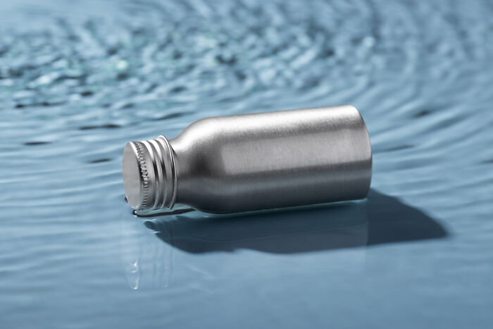 Silver bottle floating on water, illustrating a moment of doubt.