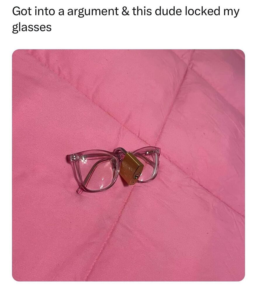 Glasses locked with a padlock on a pink quilt; a funny meme for a needed laugh.