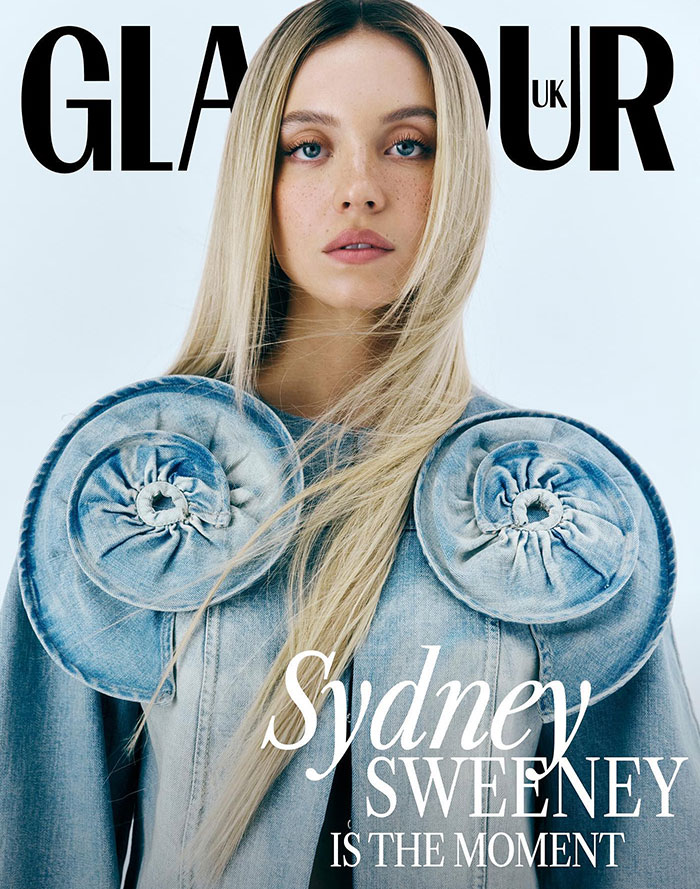 Sydney Sweeney graces the cover of Glamour UK, wearing a unique denim-inspired outfit with large circular shoulder embellishments. Her straight, long blonde hair flows down, and she gazes directly at the camera with a serene expression. The text on the cover reads, "Sydney Sweeney is the moment," emphasizing her prominence and influence. The minimalistic background highlights her striking look and presence. Sydney Sweeney graces the cover of Glamour UK, wearing a unique denim-inspired outfit with large circular shoulder embellishments. Her straight, long blonde hair flows down, and she gazes directly at the camera with a serene expression. The text on the cover reads, "Sydney Sweeney is the moment," emphasizing her prominence and influence. The minimalistic background highlights her striking look and presence.